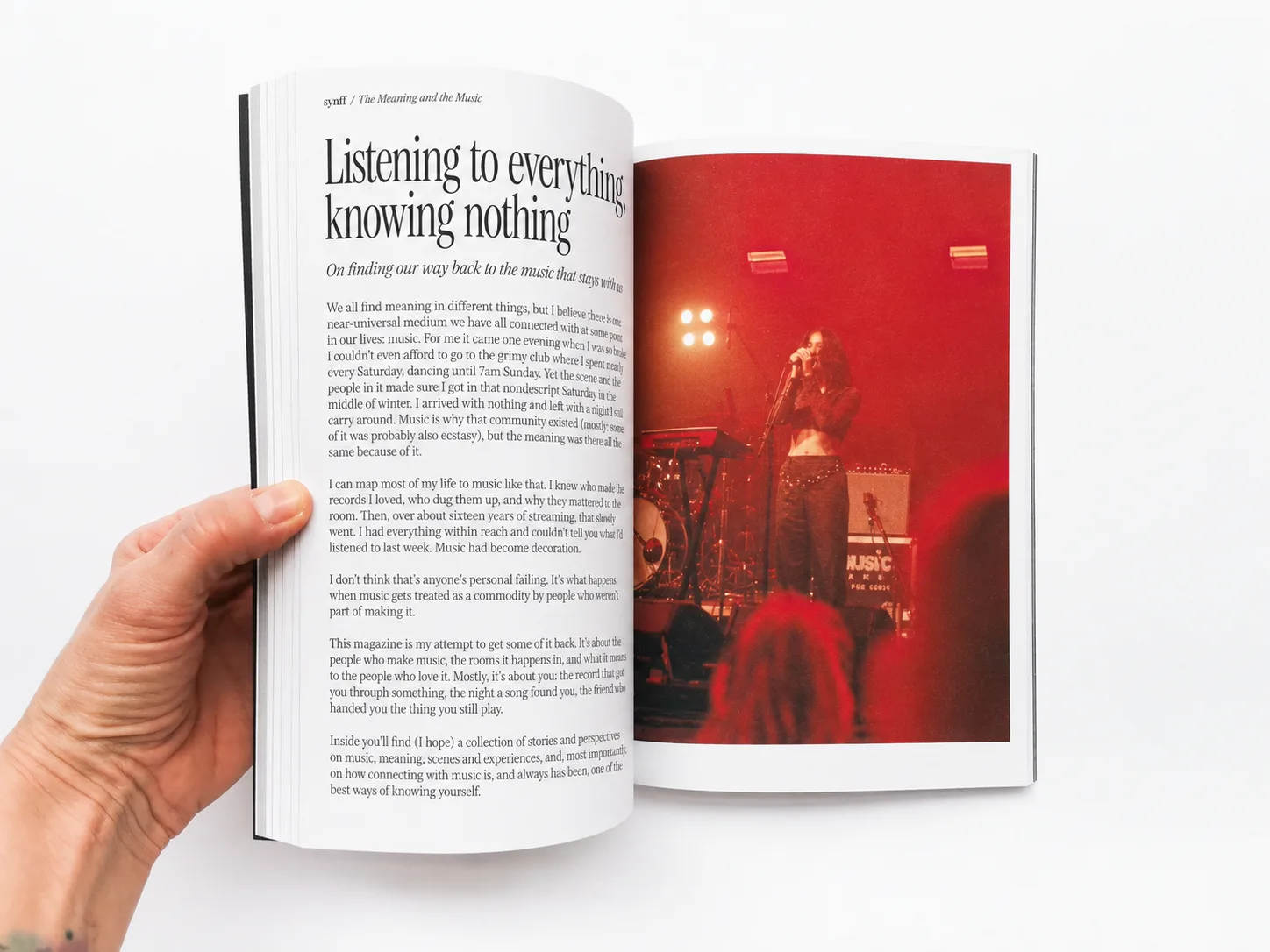 Concept of the launch issue’s editor’s note, held open opposite a photograph of a singer on a red-lit stage